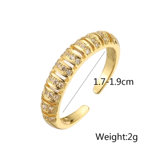 Detail view of gold geometric open ring featuring vertical ridges and cubic zirconia inlay
