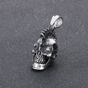 Detailed view of punk skull pendant in silver finish with mechanical gear textures