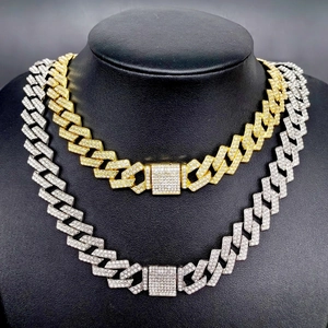 Gold and silver 14mm iced out Cuban chain necklaces with rhinestones on black bust