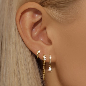 Detail of s925 silver earring set with gold plating, tassel chain, and zircon stones