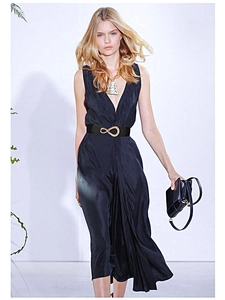 Fashionable black elastic belt with gold infinity buckle styled on a black V-neck dress