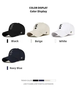 Detail of embroidered King of Spades K logo on assorted color cotton baseball caps