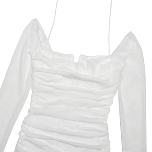 Detail of white mesh ruched dress with thin straps and sheer long sleeves design