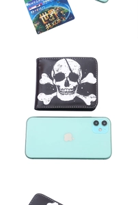 Short black faux leather bifold wallet with skull print and size reference view