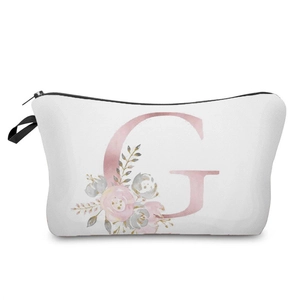 Close-up view of white cosmetic bag with pink floral letter G print and black zipper detail