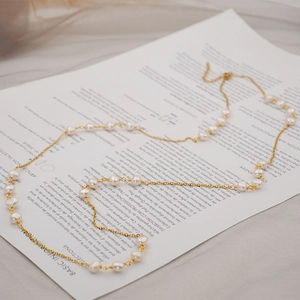 Layered long necklace with freshwater baroque pearls on a gold-plated adjustable chain