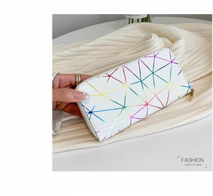Detailed view of iridescent geometric patterns on white long zip-around wallet