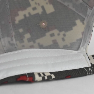Detailed close-up of the camo hat interior showing white sweatband and reinforced stitching