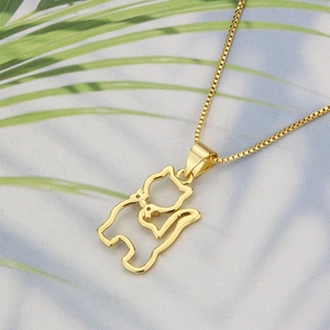 Detail of 18k gold plated cat pendant necklace featuring minimalist interlocking kittens