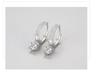Macro shot of S925 silver hoop earrings with double row diamonds and round zircon drop
