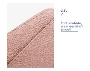Close-up of pink genuine leather wallet showing litchi texture and hand-stitched edges