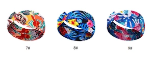 Detailed view of three knotted headbands with tropical floral and palm leaf patterns