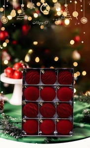 Close-up of 12 red flocked Christmas balls with smooth and spiral textures on a green cloth