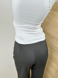Close-up of high-waist slim-fit trousers focusing on the hip and waistline tailoring