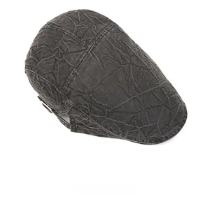 Top view of dark grey flat cap showing washed cotton fabric and vintage wrinkled texture