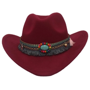 Detail of burgundy felt cowboy hat featuring turquoise stone and bohemian tassel band