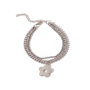 Detail view of layered silver curb chain bracelet with flower charm and size dimensions