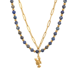 Detail of double-layer necklace with blue beads and a golden lobster pendant