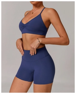 Detail view of deep blue V-neck sports bra with ruched front and racerback design
