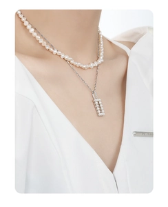Close-up of double-layer S925 silver necklace with white pearls and square pendant