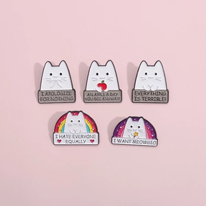 Detail of five cute cartoon cat enamel pins with humorous captions on pink background