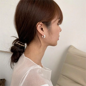 Detailed model shot of minimalist 925 silver pearl hoop earrings with a secure clasp