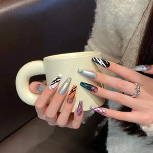 Handmade coffin press-on nails featuring zebra prints, chrome finish and colorful geometric art