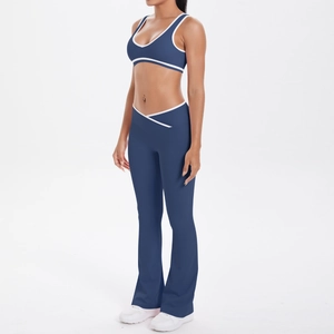 Detail of navy yoga set featuring white contrast piping and high waist cross-over waistband