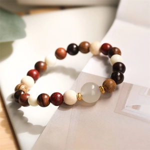 Detailed shot of multi-color wooden beads bracelet with agate stone and gold spacers