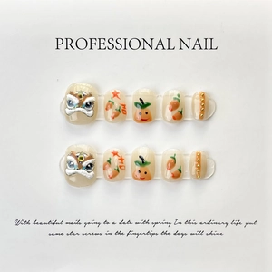 Detail of handmade press-on nails featuring 3D lion dance relief and orange persimmon patterns
