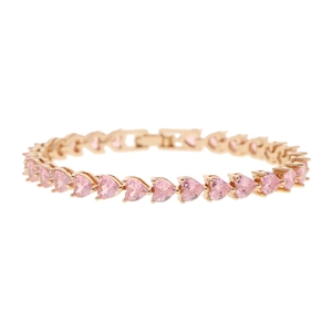 Detail of 5mm gold tennis bracelet with heart-shaped pink zircon stones on white background