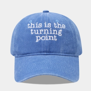 Washed cotton baseball cap in denim blue with white embroidered turning point text