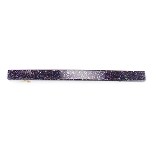 Macro detail of slim purple glitter acrylic hair clip with shimmering sequins
