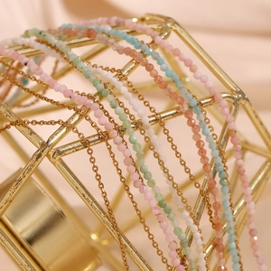 Macro shot of 18K gold plated anklets with colorful amazonite beads on gold frame