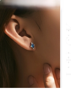 Close-up of vintage oval sapphire zircon earring worn on ear with S925 silver finish