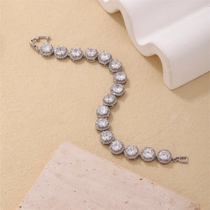 Detailed macro shot of a silver bracelet with brilliant halo-set cubic zirconia stones