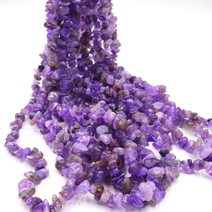 Macro shot of irregular natural purple stone beads for DIY jewelry making and crafting