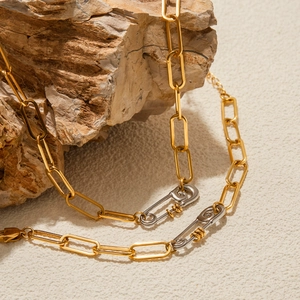 Two-tone 18K stainless steel paperclip chain necklace on a natural stone base
