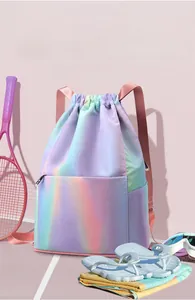 Iridescent waterproof drawstring bag with pink straps shown with tennis and swim gear