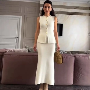 Elegant white sleeveless knit set for women featuring gold buttons and a fishtail skirt