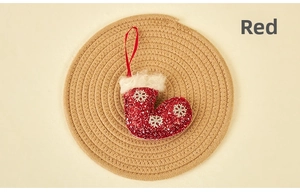 Close-up of red sequined Christmas stocking with silver snowflakes on a woven mat