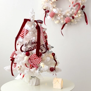 Mini white Christmas tree tabletop set with red ornaments and warm holiday lighting decor