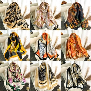 Collage of nine elegant silk scarves featuring floral and geometric patterns on chairs