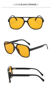 Detail view of large frame polarized sunglasses with orange lenses and black frames