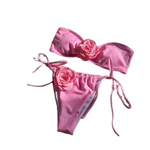 Pink bandeau bikini set with 3D rose flower details and side-tie swimming bottoms