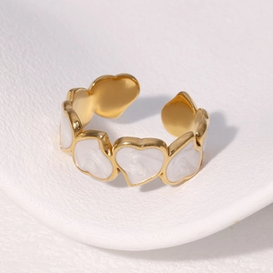 Gold stainless steel open ring with white enamel heart shapes in a minimalist design
