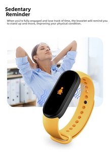Smart fitness tracker detail showing sedentary reminder icon on yellow silicone wristband