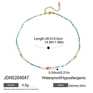 Detail of 18K gold stainless steel necklace with blue stone beads and heart charm