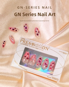 Detail of pink gradient press-on nails with red hearts, glitter, and luxury rhinestones