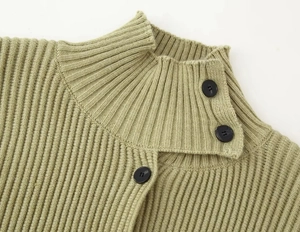 Close-up of knit cardigan high collar with decorative black side buttons and texture